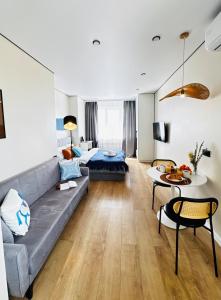a living room with a couch and a bed at Студия Aport in Pokrovka