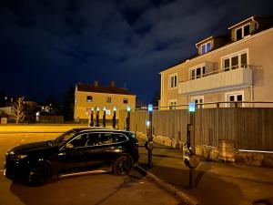 a black car parked in a parking lot at night at Stensö Room in Kalmar