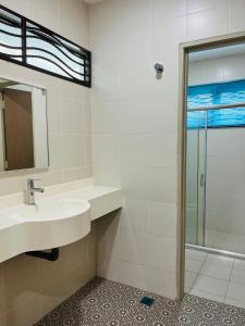 a bathroom with a sink and a shower at Sofea Homestay Ipoh V2 in Ipoh +27 photos
