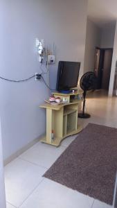 - un salon avec une télévision et une table avec un écran dans l'établissement Casa para Temporada da Tecnoshow, à Rio Verde 4 autres photos