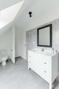 a white bathroom with a sink and a toilet at TY KAER - Charmante maison neuve tout confort in Landunvez +39 photos