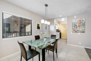 a dining room with a glass table and chairs at Ranch Club Serenity in Palm Springs