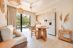 a kitchen and living room with a couch and a table at The Bungalows #1 - Boutique Hotel in Flamingo Beach - Ground Level Studio in Playa Flamingo