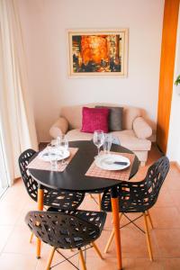 a dining room table and chairs with wine glasses on it at LUX departamentos centro JESÚS MARÍA in Jesús María +22 photos