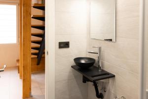 a bathroom with a bowl sink and a staircase at Carthago Suites - Puerto in Cartagena