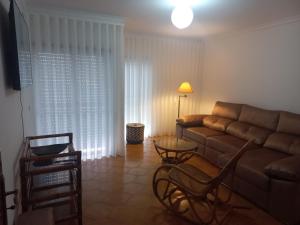 a living room with a couch and a table at Casa da Zendinha in Coimbra
