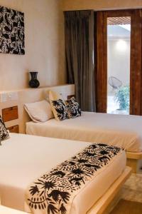 Postel nebo postele na pokoji v ubytování Hotel Casa Margot