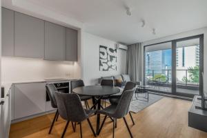 a kitchen and dining room with a table and chairs at VipWarsawApartments pl Premium 3 Rooms Apartments at Grzybowska 37 in Warsaw