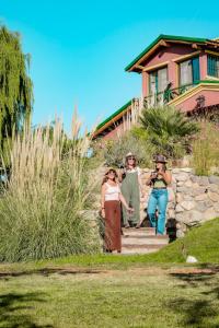 a group of people walking down a path in front of a house at Casa de Campo Kagua Kolke 6Pax By Inside in Tupungato