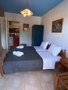 a bedroom with a large bed with two towels on it at Blue Dolphins 2 bedroomed house with court yard in Skiathos Town