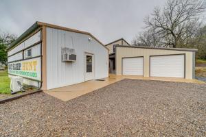 a large white garage with two garage doors at Hunt, Fish and Enjoy the Outdoors Rural Atoka Home in Atoka