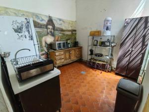 a kitchen with a painting of a man on the wall at Mudejar in Morelia