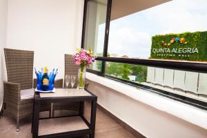 a table with flowers on it next to a window at Aspira Hotel Playa del Carmen in Playa del Carmen