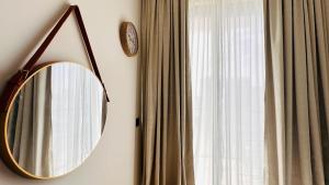 a mirror hanging on a wall next to a window at OYO 1292 Home Fully Furnished 1bed Apt @JVC in Dubai