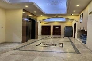 a hallway with a room with a ceiling at Super OYO 149 Bait Al Ghubaira Furnished Flat in Salalah