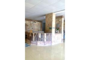 a lobby of a building with a stone wall at OYO 157 Dream Barka Hotel in Barka