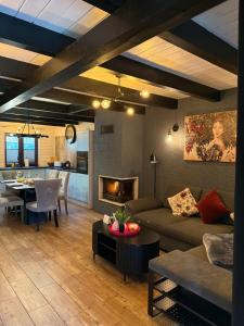 a living room with a couch and a dining room at Domek w lesie nad zalewem in Chańcza