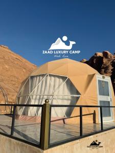 a tent in the desert with a sign that reads had luxury camp at Wadi Rum ZAAD luxury Camp in Wadi Rum