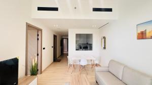 a living room with a couch and a table at OYO 1287 Home Fully Furnished 1Bed At JVC in Dubai +18 photos