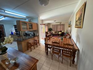 a kitchen and dining room with a table and chairs at Whole House to Rent for Holidays in George