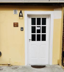 a white garage door with a light above it at Depto CENTRICO AURA in Río Gallegos