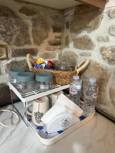 a shelf with a basket and bottles of water at Petra Home Pyrgi in Pyrgi +25 photos