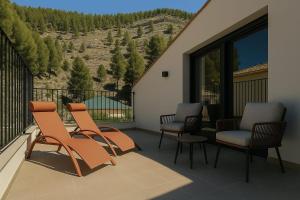 a balcony with chairs and a view of a mountain at Kalea Elysivm in Alcalá del Júcar