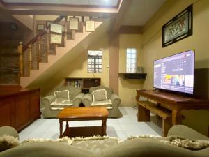 a living room with a piano and a staircase at Mountain Villa View Three spacious bedrooms in Baguio