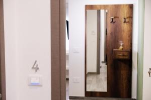 a bathroom with a mirror and a sink at Beso Dimore Partenopee in Naples +46 photos