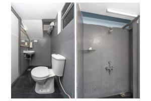 a bathroom with a white toilet and a shower at Grace Residency in Puducherry Airpoert