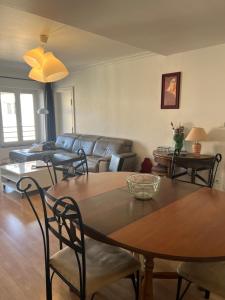 a living room with a table and a couch at Le Central Victoria VII - Central district - Stanislas - Train station in Nancy