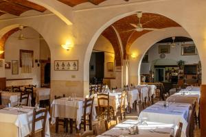 a dining room with white tables and chairs at Collebrunacchi B&B in San Miniato