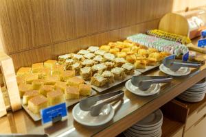 a buffet of pastries and desserts on a table at Fusion Hplus Express + in Brasilia +17 photos