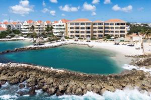 an aerial view of a resort on a beach at The Strand - The Beach, Penthouse 4A in Willemstad