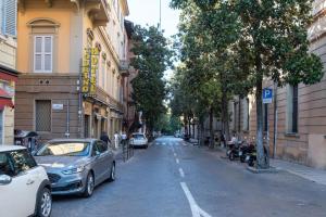 a street with cars parked on the side of the road at DUE TORRI 1 LUXURY PALACE- BEDINBOLOGNAcentro in Bologna