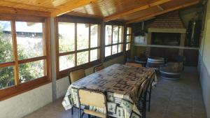a dining room with a table and some windows at Casa de montaña Los Picus in Potrerillos +11 photos