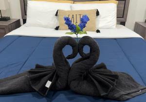 two swansuitsrendered to look like hearts sitting on a bed at Luxury Midtown Suite in Houston near TMC and NRG in Houston