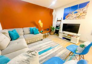 a living room with a couch and a tv at Luxury Midtown Suite in Houston near TMC and NRG in Houston