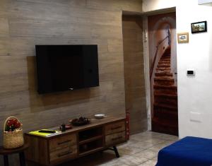 a living room with a flat screen tv on a wall at Panariello a Portamedina in Naples