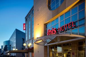 a building with a sign that reads his hotel at ibis Vichy in Vichy