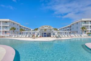 a pool with chairs and tables in a resort at Gulf Shores Plantation-East 3210 in Gulf Shores