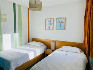 Postel nebo postele na pokoji v ubytování WEAA Hotel
