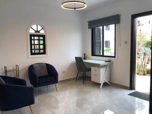 a room with a desk and chairs and a window at Luxurious 3-Bed Villa, Modern Decor, Communal Pool in Paphos