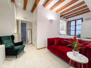 a living room with a red couch and a table at Apartments Lovro & Lena in Dubrovnik