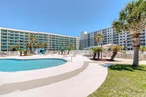 a resort with a pool and palm trees and a building at 6512 Gulf Shores Plantation-Palms in Gulf Shores