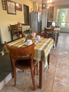 a table with a striped table cloth on it in a restaurant at Hosteria Costa Norte in Colón