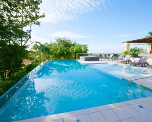 a swimming pool with a view of the ocean at Lucero Residences Golf & Wellness Resort in Boquete