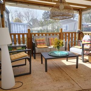 a porch with a couch and a coffee table at Jolie mobilhome 331 in Gastes