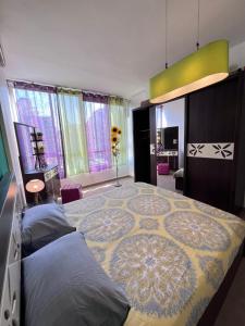 a bedroom with a large bed with a rug on it at Byout Beirut G3 in Beirut