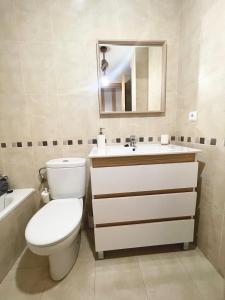 a bathroom with a toilet and a sink and a mirror at Residencial Neo Txelmisa in María de Huerva +16 photos